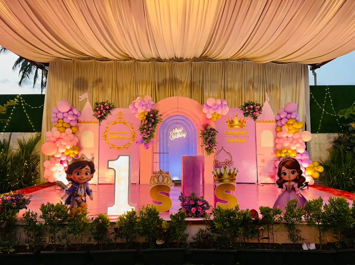 Pink princess castle themed birthday stage at dusk